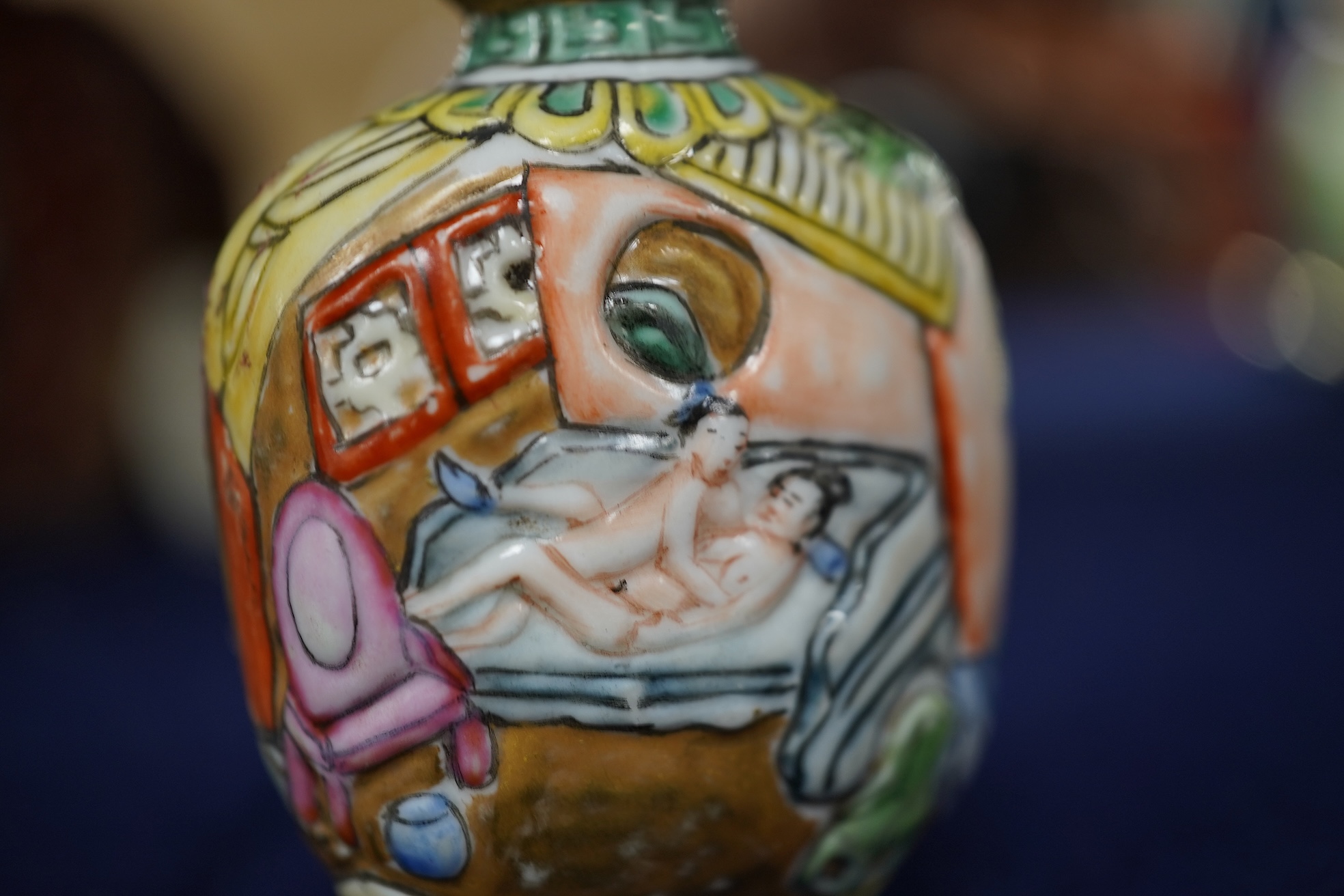 A Chinese enamelled and moulded porcelain erotic subject snuff bottle and stopper, Guangxu mark and possibly of the period, 6.5cm